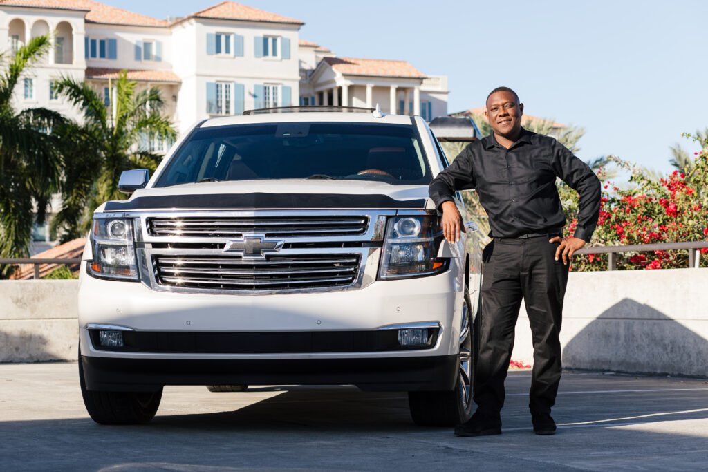 Secure Taxi driver standing beside a private SUV in Providenciales